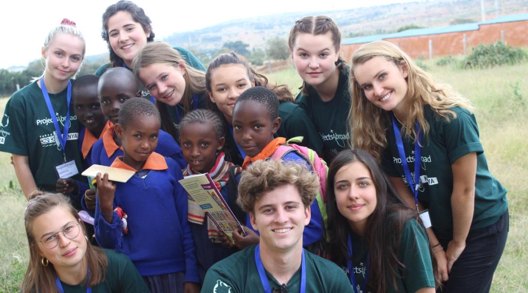 Volunteers help last minute on one of our projects in Kenya this summer. Last minute High School Special volunteers in Kenya help local children with their homework on a Childcare project.